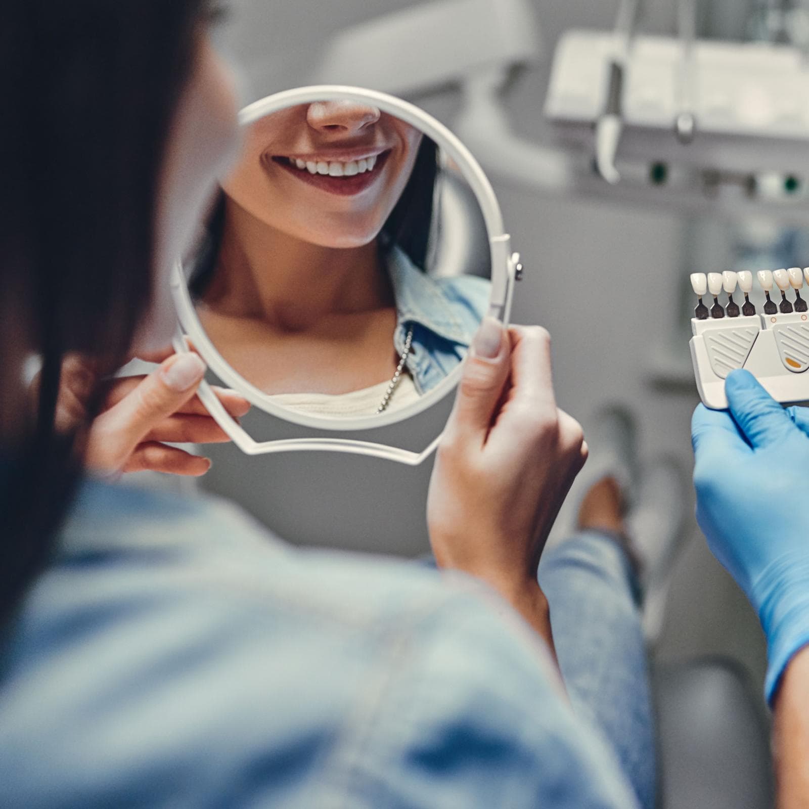 Dentist examining teeth with a dental mirror